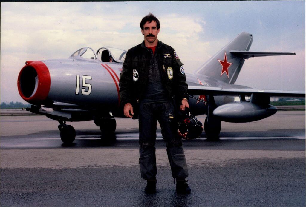 Paul Entrekin, Author of Mr. MiG, posing with his MiG 15 aircraft.
